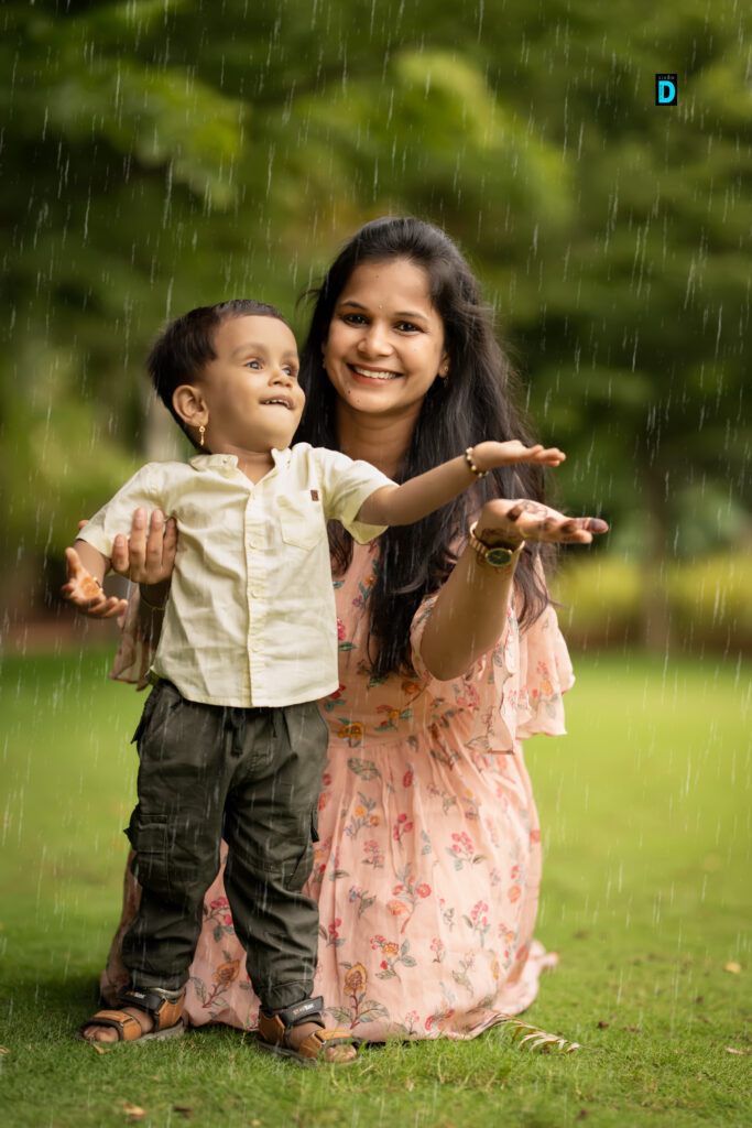 Joyful baby and mother enjoying rain at Studio D photoshoot