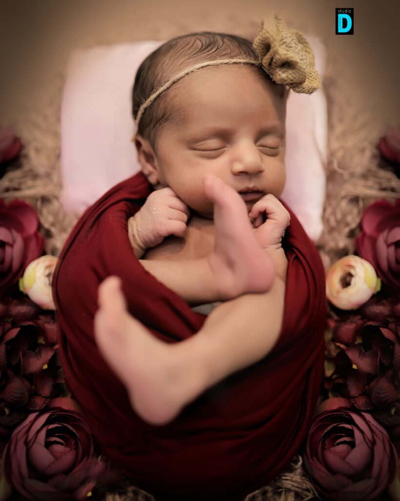 Cozy newborn baby wrapped in a blanket during a photoshoot