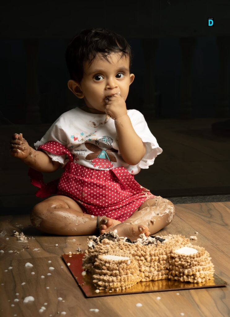 Baby enjoying a cake smash photoshoot at Studio D