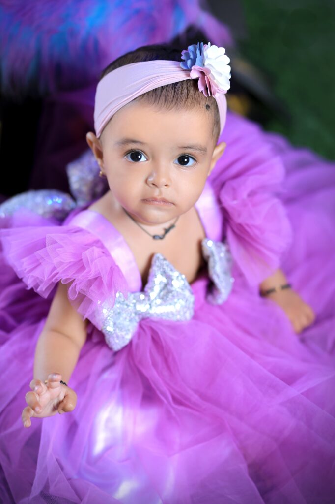Baby girl smiling in an elegant princess outfit